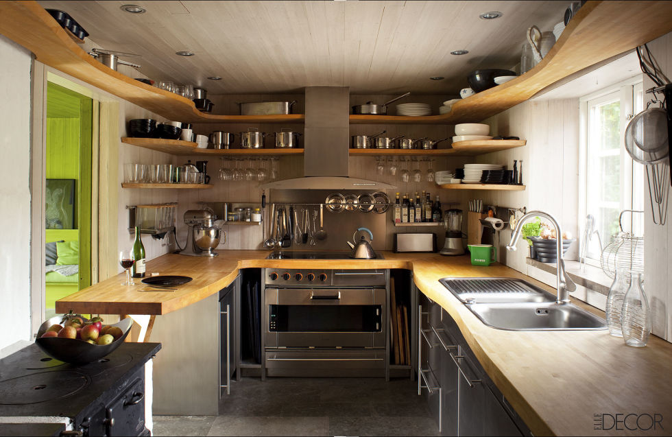 Designed by Gert Wingardh, this Swedish kitchen's custom countertops and shelving are birch, the oven and cooktop are by Gaggenau, and the antique stove in the foreground is original to the house.
Tour the entire home.
