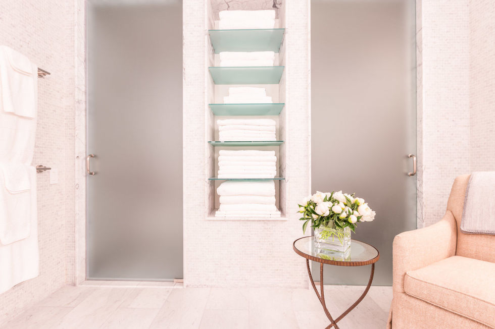 Bathrooms are the one space that seem to constantly end up overrun by clutter, but according to Houzz, 2016 will see an end to that. It's time to take your bathroom back, and to achieve that goal is to introduce some homey items — like the plush chairs and fresh flowers here — into the space.