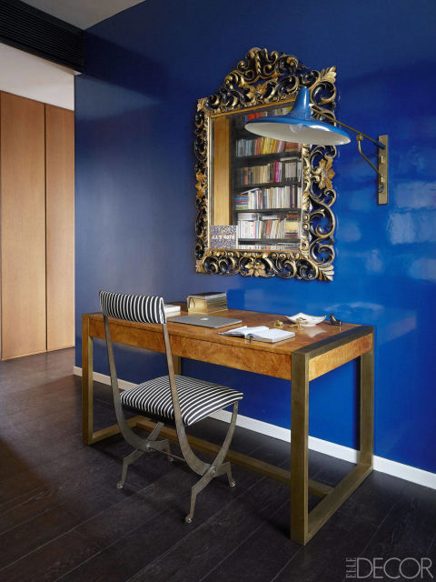 I may not have hired an interior designer, but I found plenty of advice from every furniture dealer in town. Often they told me I was nuts, but sometimes I got an astonished look of approval—such as for a set of rusted iron armchairs I fished out of the city's junkyard. I brought them to an auto-body shop, where the perplexed mechanics promptly told me that they definitely could not paint them the same red as my vintage Fiat Cinquecento. But they did. A 1970s Italian walnut desk from Flair Milano, a 1940s French chair, and a 1950s Italian sconce in the home office.