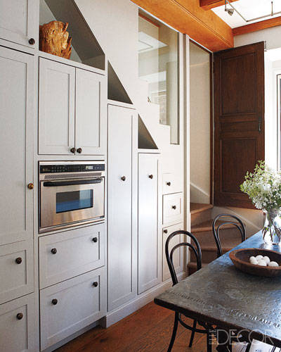 The wall of custom-made cabinetry in celebrity hairstylist Frédéric Fekkai's Manhattan kitchen is Shaker-inspired and built into the space behind the staircase.
