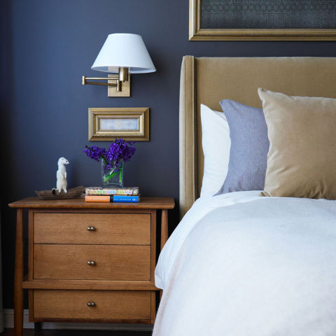 "The bedside table should be dressed with proper reading lights. I like a wall mounted version or a sconce because it gives you more real estate on the bedside table. I also put bedside lamps on a dimmer, being able to adjust to lower lighting helps get your body ready for sleep," says Call. 
Photography by Philip Ficks
